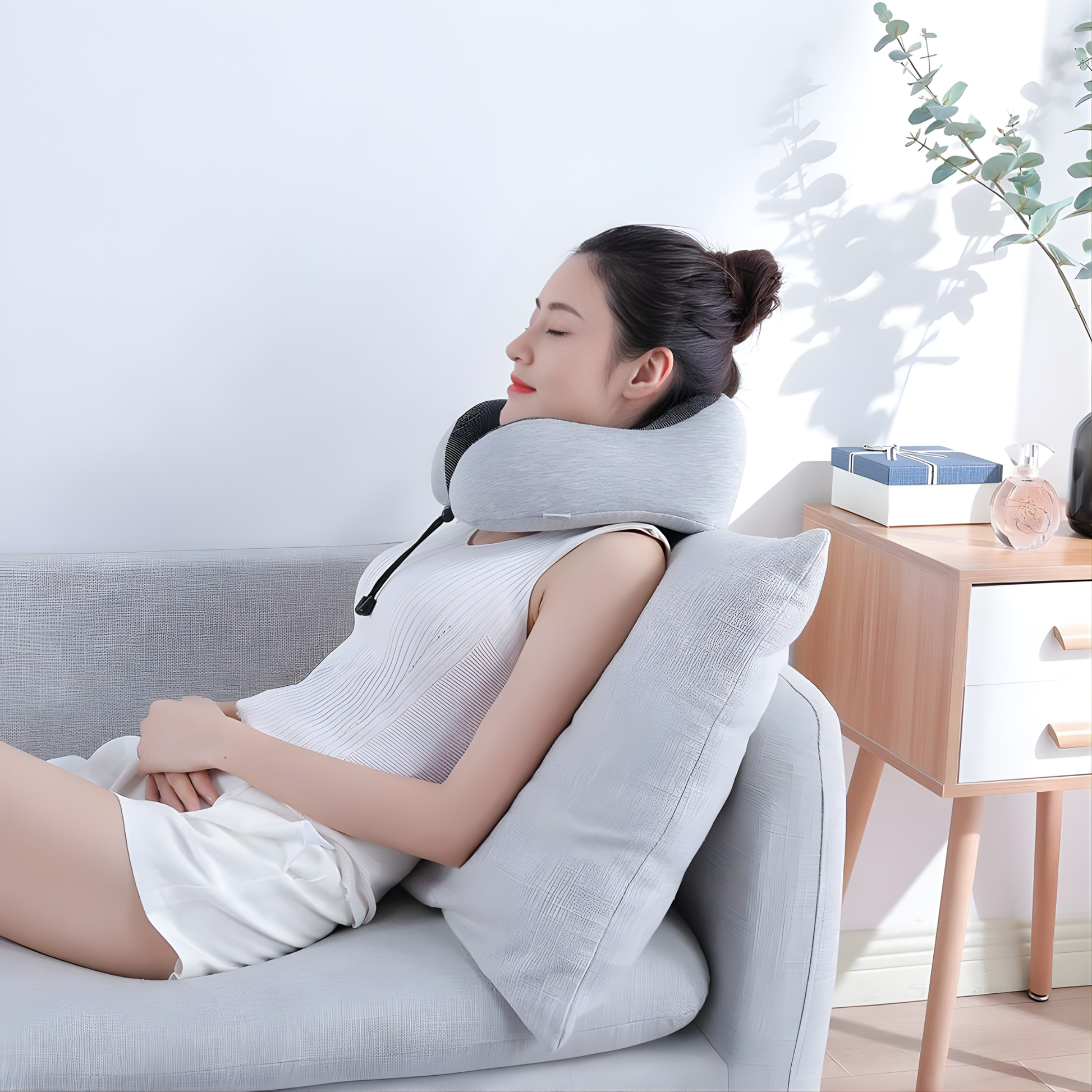 Adjustable memory foam travel neck pillow worn by woman 
relaxing on sofa at home for neck support and comfort